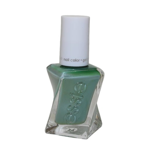 Green nail polish bottle with white cap on a light gray background