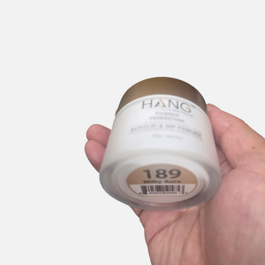 Beauty Zone Nail Supply Hang 189 Milky Aura acrylic and dip powder jar held in hand